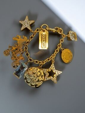 Coach Gold-Tone Charm Bracelet with Clear Crystal Accents and Photo Locket